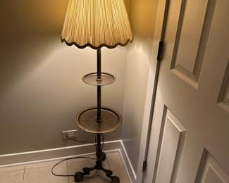 Two tiered brass table lamp with ball and claw feet.