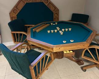 Octagonal game table with four chairs. Top can be flipped to switch between dining, poker, or bumper pool.