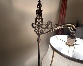 Antique floor lamp with ornate metalwork.