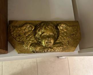 Gilded relief cherub wall plaque.