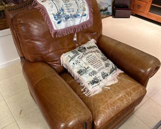Leather recliner with nailhead trim and rolled arms.