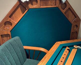 Octagonal game table with four chairs. Top can be flipped to switch between dining, poker, or bumper pool. Alternate view.