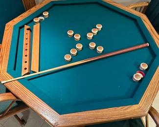 Octagonal game table with four chairs. Top can be flipped to switch between dining, poker, or bumper pool. Alternate view.