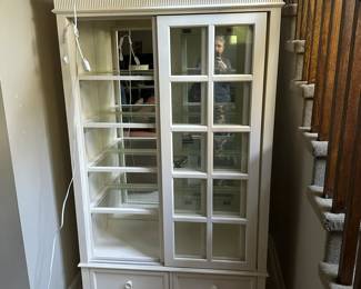 Quality lighted curio cabinet with sliding doors.