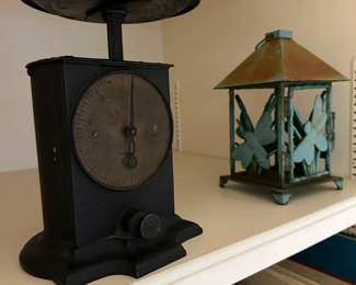 Antique scale with dragonfly lantern.