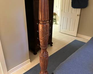 Stunning carved wood four-poster bed.