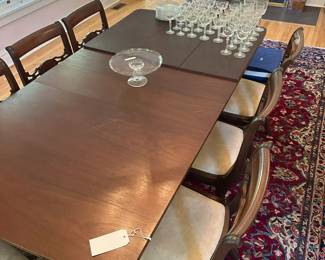 Vintage dining set with reupholstered chairs in neutral fabric.
