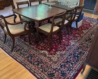 Vintage dining set with reupholstered chairs in neutral fabric.