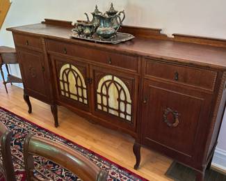 Antique sideboard with stained glass panels.