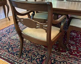 Vintage dining set with reupholstered chairs in neutral fabric.