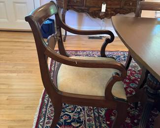 Vintage dining set with reupholstered chairs in neutral fabric.