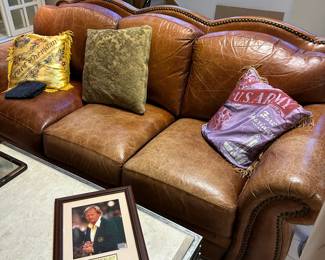 Leather sofa with nailhead trim and rolled arms.