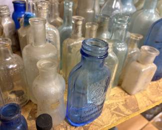 Lots of blue and green antique bottles