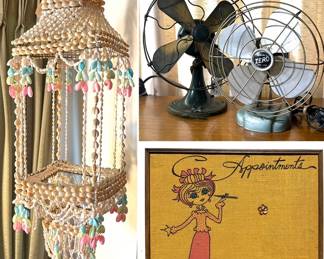 A vintage seashell hanging planter, two vintage electric fans and vintage wall hanging appointment board