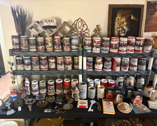 A collection of vintage Budweiser beer steins and mugs.