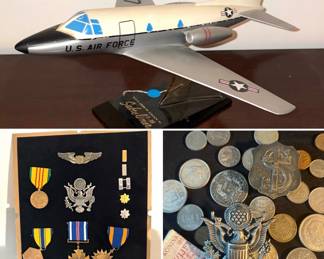 A model of a North American T-39 Sabreliner, military medals including an Air Force Command Pilot badge, collection of various foreign coins including sterling coins