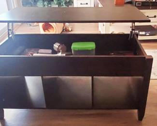 lift-top coffee table with a hidden storage compartment and open shelves. 