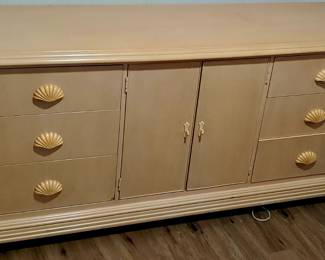 wooden dresser with shell-shaped drawer pulls.