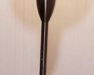 floor lamp with a bell-shaped fabric shade and a metal base.
