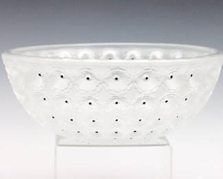 A mid 20th century Lalique frosted Crystal "Nemours" bowl. Molded floral design with Black enameled accents. Etched "Lalique France" signature. Slight wear. 10" diameter x 4" high overall.
