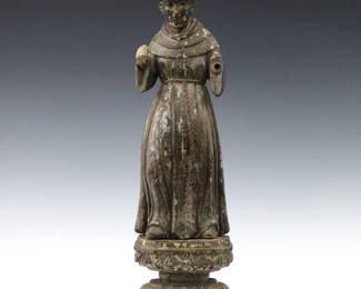 A 19th Century Spanish Colonial Santos figure. Carved wooden figure with polychrome decoration and inset glass eyes, depicting St. Francis atop an ornate carved wood plinth Wear, some damage, shrinkage, lacks his left hand and part of his left foot. 17 3/4" high.