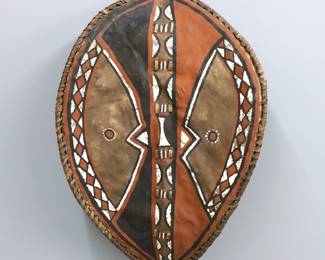 An African Maasai culture Elongo shield. Animal hide stretched across a bentwood frame with leather lashings and polychrome decoration. Some wear. 36" high.