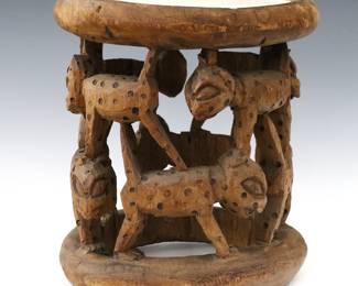 An African figural seat from the Babanki people, Cameroon. Carved wooden stool with openwork leopard design with a White painted top. Some wear and shrinkage. 11 x 12 3/4" high overall.