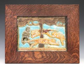 A Pewabic Art Pottery tile. Rectangular tile decorated with a relief image of tigers chasing a boy around a tree. Presented in a custom Quarter Sawn Oak frame by Family Woodworks. Tile impressed "Pewabic Detroit" verso. Slight crazing. Tile is 8 3/4 x 6 1/4" high, framed 12 1/4 x 9 3/4" high overall.