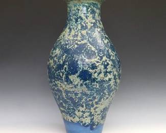An early 20th century Pewabic Art Pottery vase. Baluster form with flared rim and thick mottled lava glaze in shades of Iridescent Golden Green on a Blue ground. Unmarked. Minor wear. 15 3/4" high.