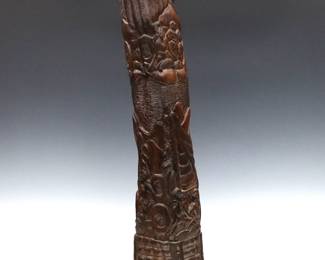 An Oceanic carved ancestral totem or post from Palau. Carved hardwood post depicting emblematic scenes of daily and ceremonial life with multiple figures among palm trees. Refinished with minor wear.