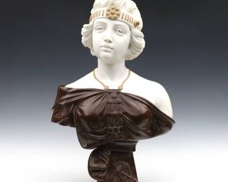 After Emmanuel Villanis, French, 1858-1914. A turn of the century Art Nouveau Marble bust, titled "Zora". Solid Carrara Marble bust of a young maiden in a flowing Brown Marble dress with Tan Granite accessories. Carved "Zora" at base. Minor surface wear overall, a few small losses to base. 24 1/2" high.