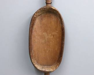 A Papua New Guinea carved food bowl. Carved oval form wooden bowl with two handles. Some wear, minor damage to edges. 34" long.