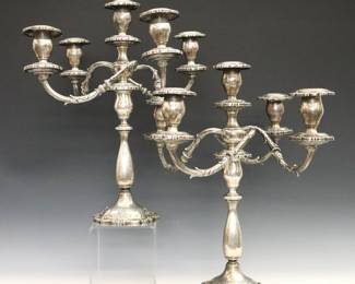 A pair of mid 20th century Fisher "English Rose" pattern Sterling Silver candelabra. Weighted two-part convertible candelabra with five light design, four scrolled arms and a baluster stem with circular foot. Each marked "Fisher / Sterling Weighted" and "English Rose / 2450". Minor surface wear and denting. 17 1/4" high.