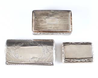 Three early 19th to early 20th century English Sterling Silver snuff boxes. Rectangular hinged boxes with scrolled engraved and cast decoration, includes a Georgian box dated 1823 by Thomas Newbold, a box dated 1853 by Yapp & Woodward, and another dated 1911 by Henry Williamson LTD. Each with impressed Birmingham hallmarks, maker's marks and date letters. 5.47 troy ozs total. Some surface wear, Georgian box with engraved inscription at interior. Up to 3 1/4" long.