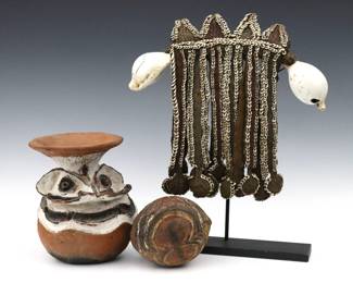 Three Papua New Guinea items. Includes a Fofana male pectoral ornament with braided natural fibers and large cowrie shell accents, an Earthenware figural Sago jar with polychrome decoration, and a carved coconut whistle with polychrome decoration. Some wear, one cowrie shell and coconut repaired. Up to 12" high, not including stand.