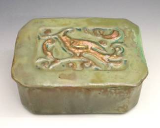 A mid 20th century Pewabic Art Pottery covered box. Rectangular form with canted corners, featuring a relief bird design at the lid and Iridescent glaze in mottled shades of Green and Gold. Impressed "Pewabic Detroit" mark. Minor wear and crazing. 5 x 3 3/4 x 2" high overall.