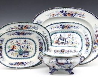 Five 19th century English Ironstone serving pieces. Multi-color Chinoiserie decoration with floral borders. Includes five serving platters and a soup tureen. Impressed and printed "C" with "2487" pattern number, possibly unmarked Copeland Spode. Tureen lid with some hairlines, one platter with production firing crack, minor edge flakes and craquelure. Platters up to 22" long, tureen 12 x 9" high overall.