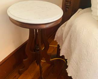 one of two marble top bedside tables