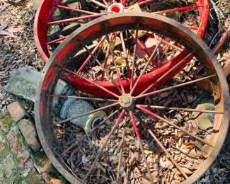 two antique iron wagon wheels