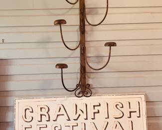 vintage wall mounted hat rack and an early Crawfish Festival sign