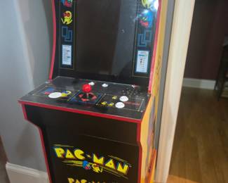 Classic Arcade1Up Pac-Man cabinet, features original graphics, joystick, and control panel with bright display. A fun addition to any game room or entertainment space. Approx. 45"H x 19"W x 22"D.
