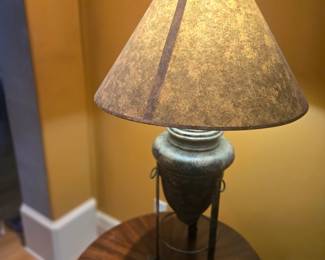 Textured metal lamp with earthy tones and parchment-style shade. Perfect for end table or office use. Approx. 25"H.