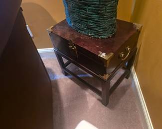 Compact dark wood side table with brass corner accents and drawer handle. Ideal for lamp or decorative display. Approx. 22"H x 18"W x 18"D.