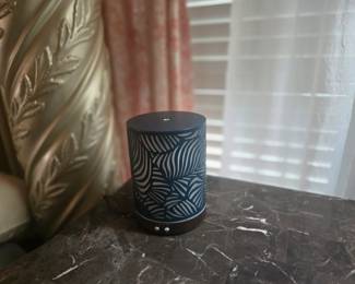 Modern essential oil diffuser with blue leaf-patterned cover and soft ambient light. Compact size, works perfectly, and adds a touch of style to any room.