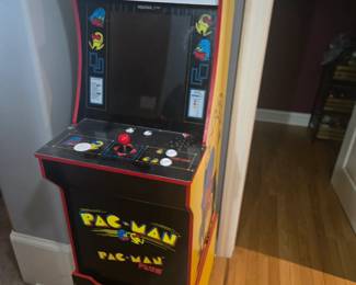 Classic Arcade1Up Pac-Man cabinet features original graphics, joystick, and control panel with bright display. A fun addition to any game room or entertainment space. Approx. 45"H x 19"W x 22"D.