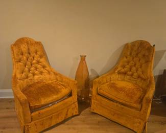 Mid-century style velvet chairs in rich mustard tone with tufted back. Comfortable and stylish—approx. 34” high.