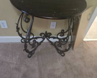 Elegant wrought iron base with scrolled detailing and a dark wood top. Perfect for an entryway or hallway accent. Some surface wear consistent with age.
Approx. 30”W x 14”D x 30”H.