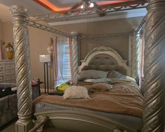 King Canopy Bed – Four-poster design with spiral-carved columns, tufted upholstered headboard, and ornate crown molding. Approx. 86” H x 82” W x 88” L.