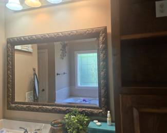 Beautifully detailed mirror with an embossed bronze-style frame. Ideal for bathroom, hallway, or bedroom décor. Approx. 36” H x 48” W.