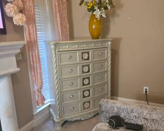 9-drawer chest with floral carvings, metallic champagne finish, and crystal-style pulls. Approx. 44” W x 19” D x 56” H.